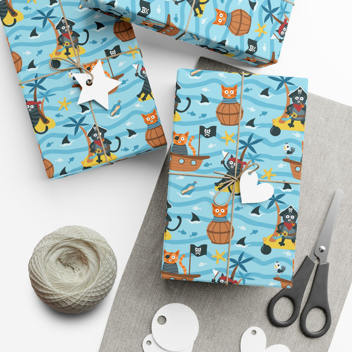 Cat Pirate-themed gift wrap with scissors, yarn, and tags on a white surface