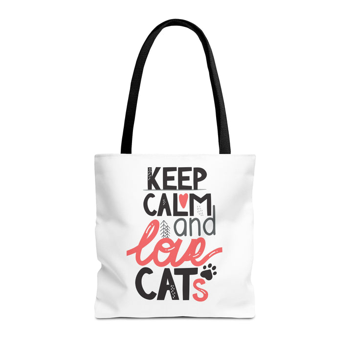 A white canvas tote bag with black handles, featuring the printed text 'KEEP CALM and love CATS' in black and coral pink lettering on the front, set against a plain white background.