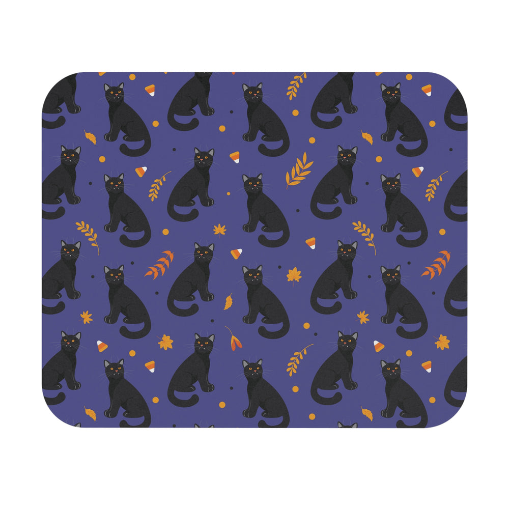 Patterned mouse pad with black cats and autumn leaves on a blue background
