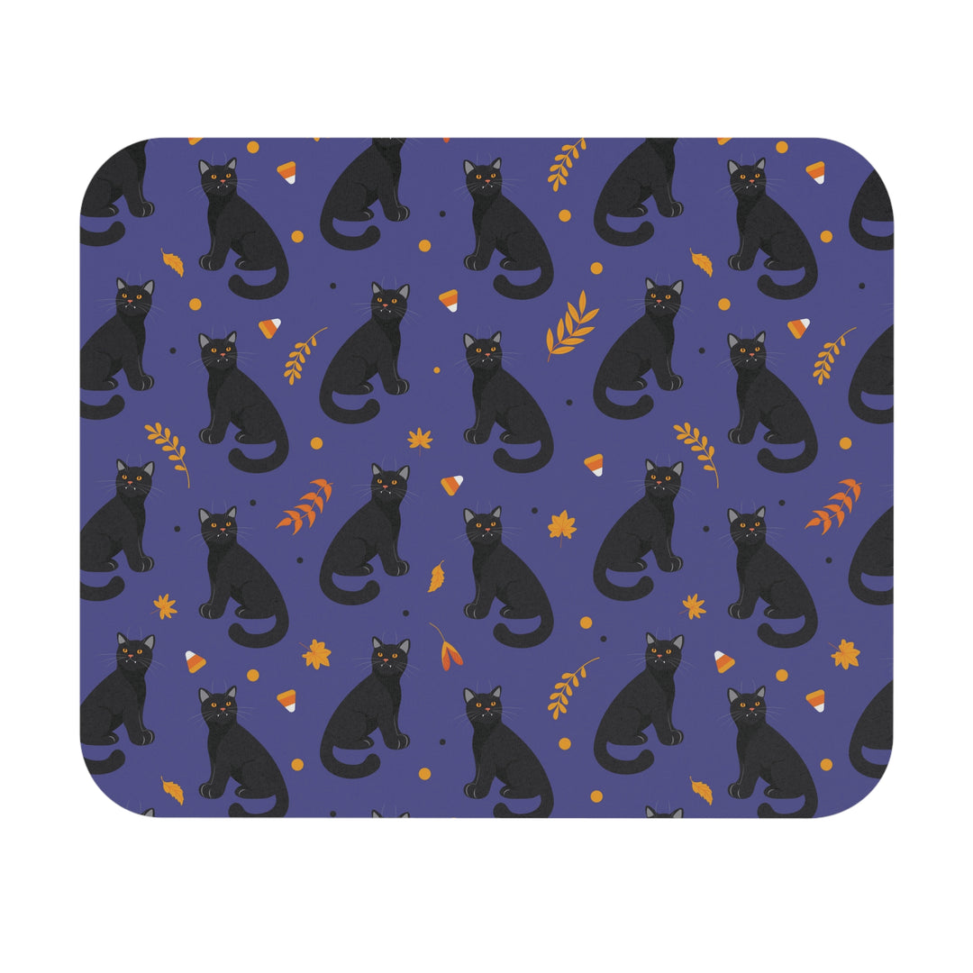 Patterned mouse pad with black cats and autumn leaves on a blue background