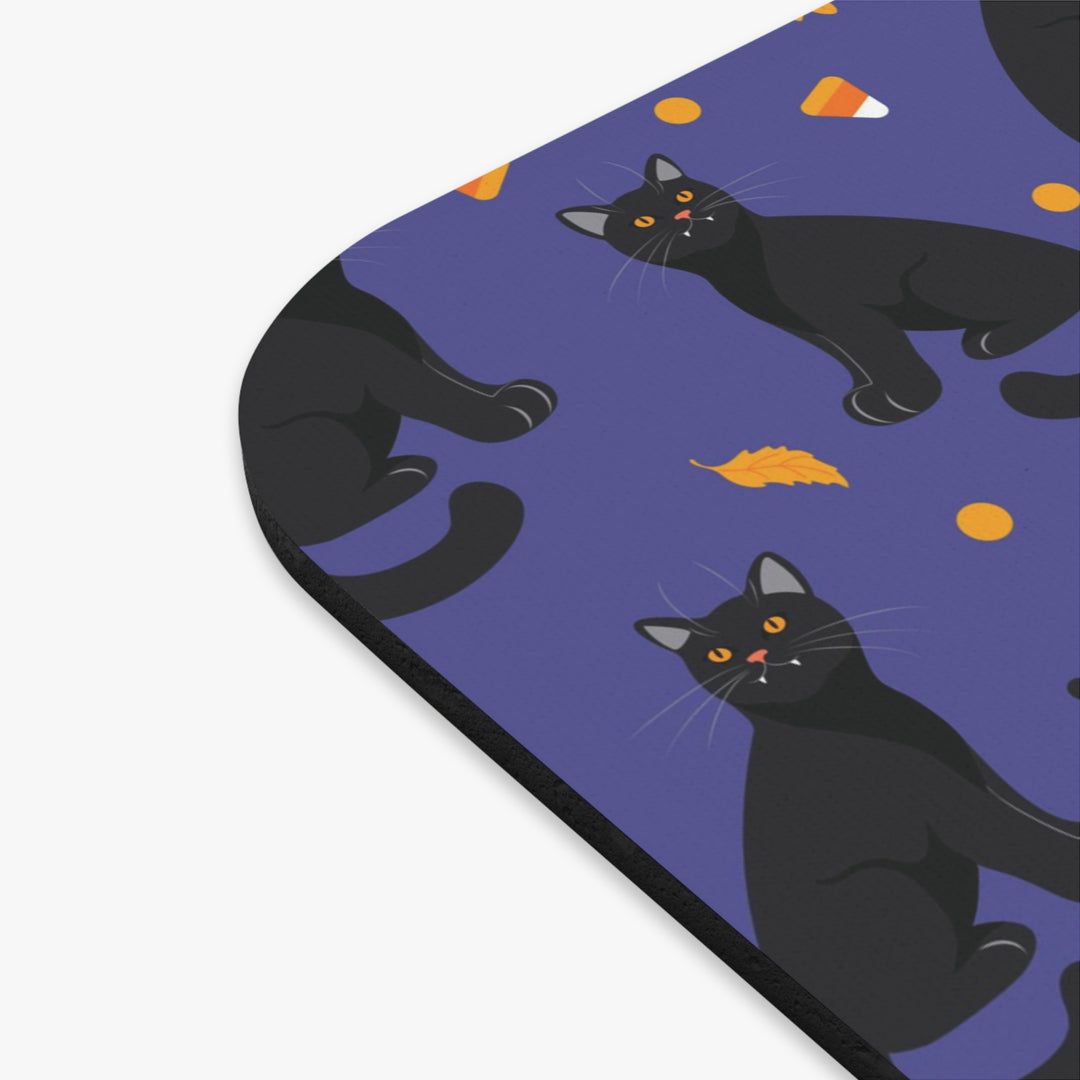 mouse pad with black cat illustrations on a purple background
