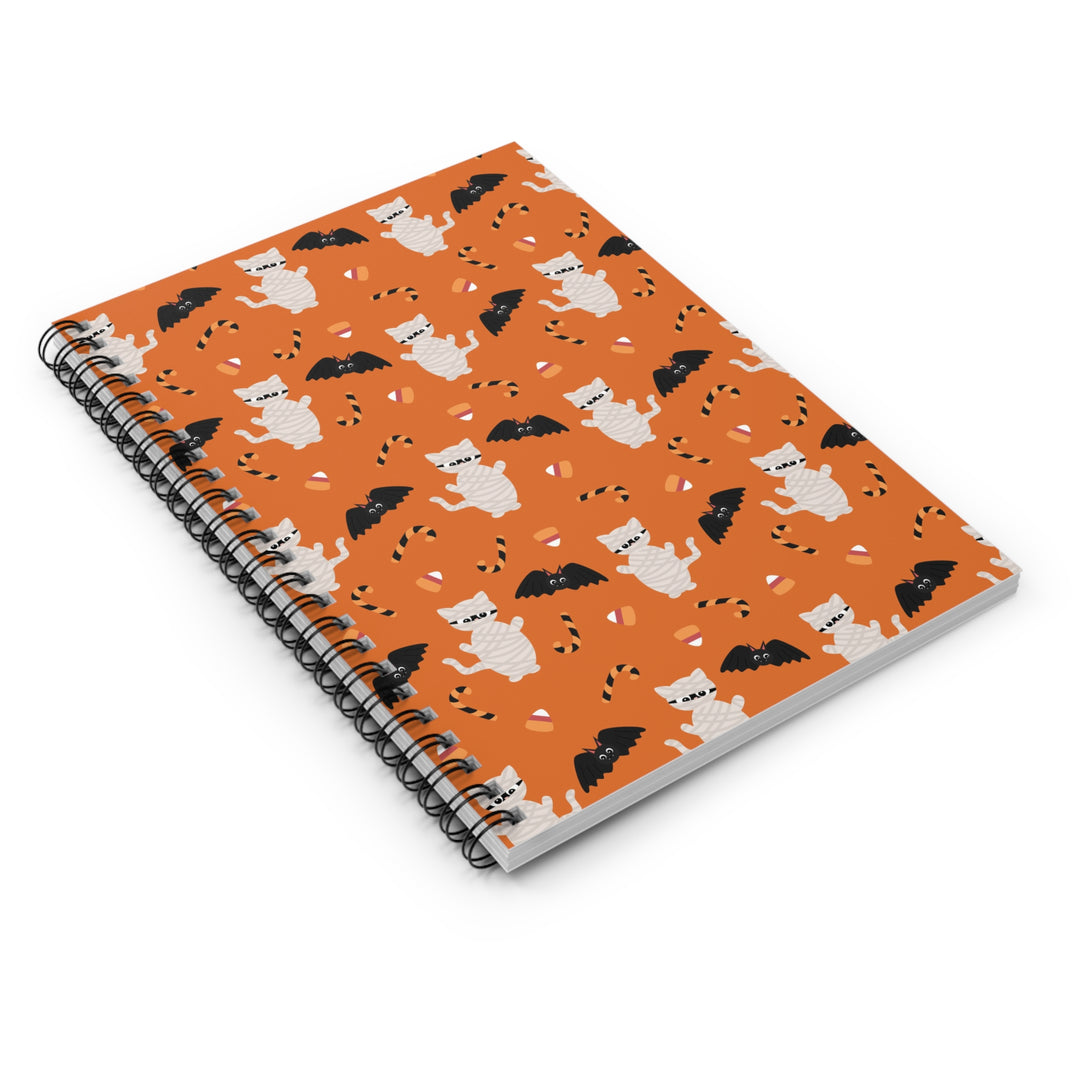 Spiral-bound notebook with Halloween-themed cover featuring cats and bats on an orange background