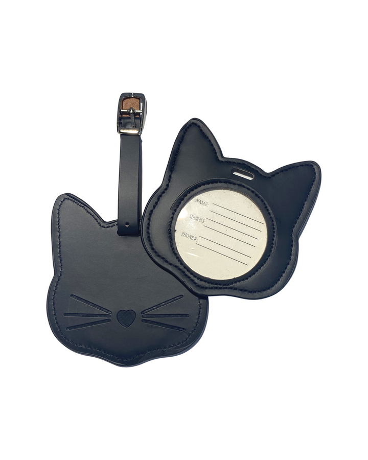 A pair of black cat-shaped luggage tags with embossed facial features and a silver-tone metal buckle strap, displayed against a solid white background.