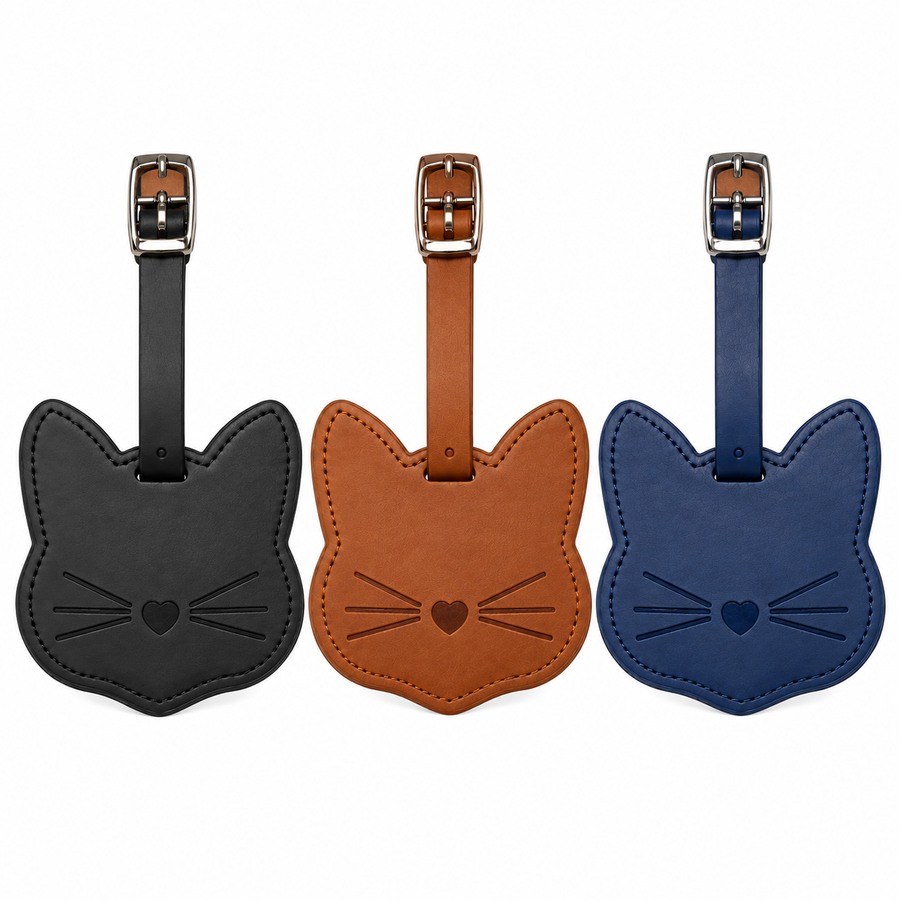 Three cat-shaped leather luggage tags in black, tan, and navy blue, each with a matching strap and silver metal buckle, displayed side-by-side on a white background.
