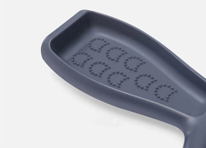 Gray silicone mold with embossed cat heads on a white background